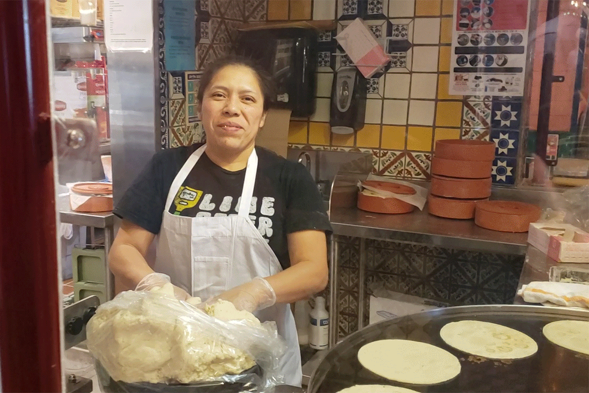 Chuy's worker handmaking and cooking tortillas.