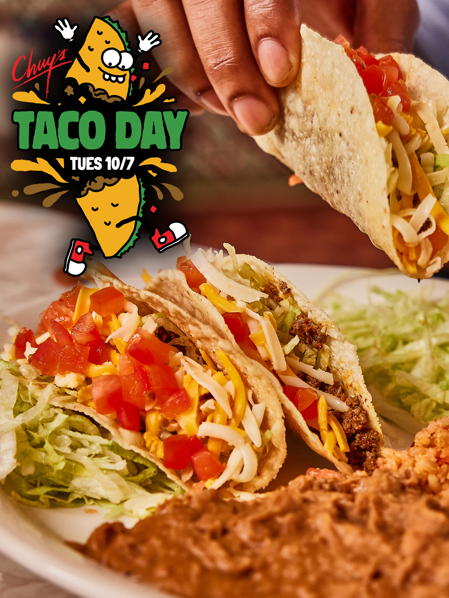 A plate of tacos next to a side of refried beans with text that reads: 'Chuy's Taco Day Tues 10/7.'