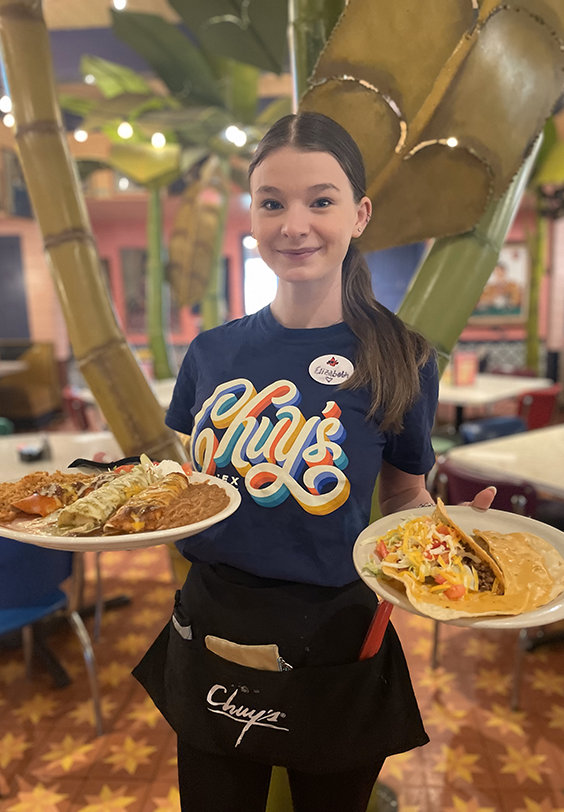Chuy's server serving the famous Elvis Memorial Combo.
