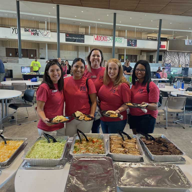 Five women from the PTA enjoying catered Chuy's.
