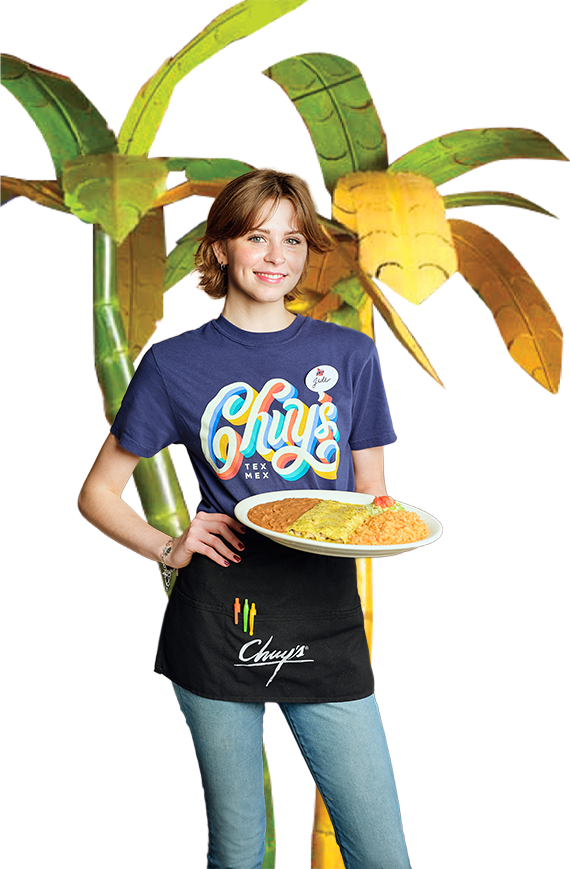 Chuy's server standing in front of palm tree ready to serve a delicious plate of Tex-Mex food.