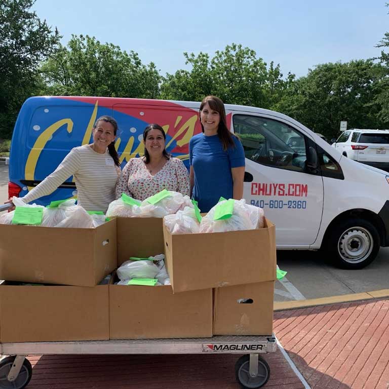 Teachers receiving a Chuy's care package.