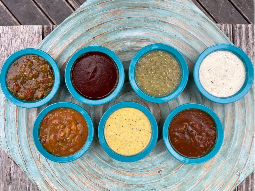 Showcase of Chuy's sauces next to each other. 
